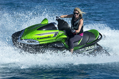 Blonde Girl enjoy riding green black Yamaha Waverunners Jet Ski 1800cc from Jet Ski rentals in Dubai